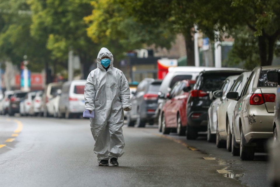  A lone medic walks down a deserted street in crisis-hit Wuhan