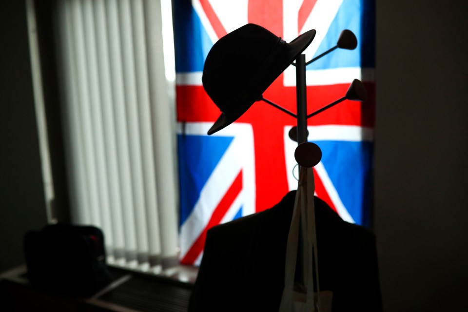  A hat hangs on a coat stand in front of the Union flag in the office of British European Parliament member Nigel Farage at the European Parliament in Brussels