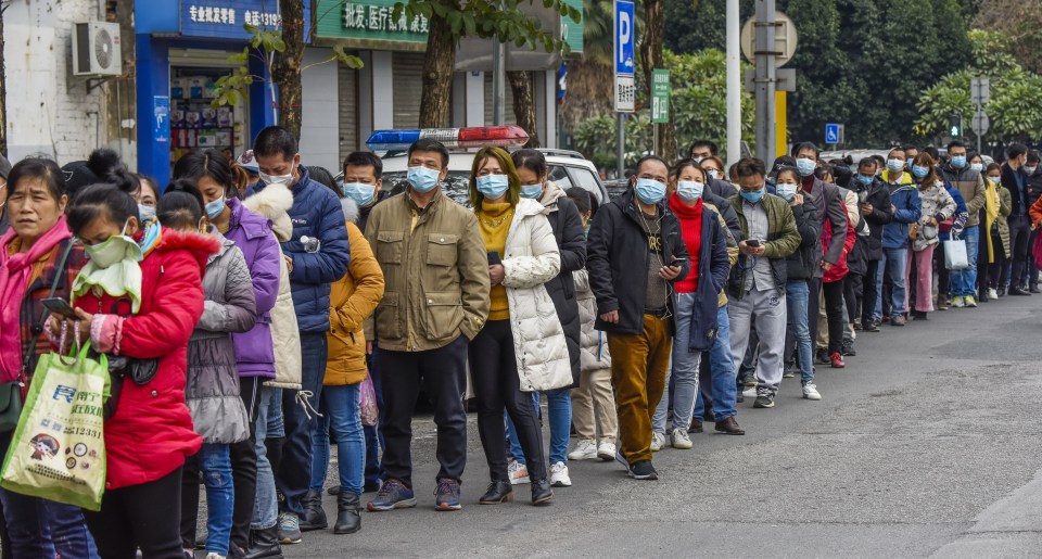  Residents form a long queue to buy masks at a medical company as masks shortage continues amid the coronavirus outbreak in China