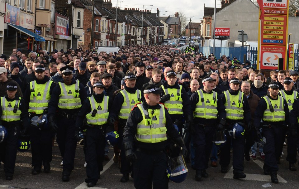 Millwall fans being escorted to a game against Luton in 2013 – the Metropolitan Police has considered suing Millwall FC over its fans’ violence in the past