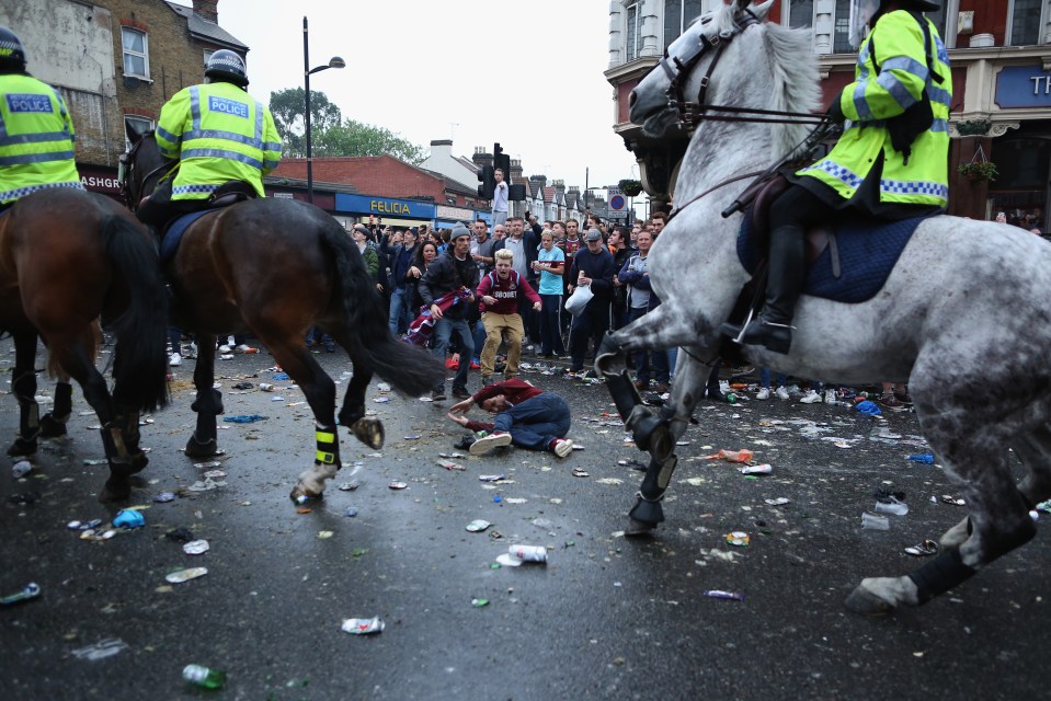 A West Ham fan knocked down by police horses after bottles were thrown outside the club’s old ground in Upton Park, east London