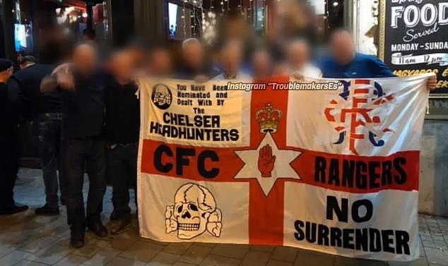 A Chelsea Headhunters flag being unfurled in Budapest in 2018 – the skull symbol was used by the Nazi organisation which ran concentration camps