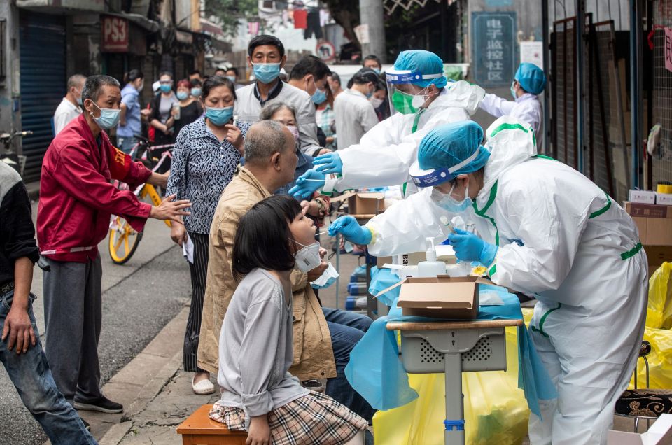  Medical workers take swabs from residents to be tested for the coronavirus, in a street in Wuhan