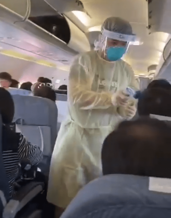 Footage claims to show medics screening passengers on a plane to Macao from Wuhan