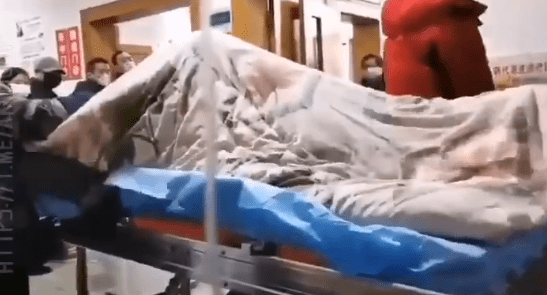  The shaking patient was captured on film on a grubby looking hospital strecther