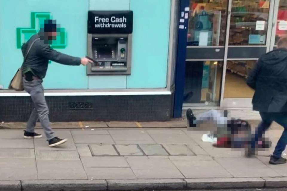 Undercover officers holding handguns swoop in on the suspect as he lies gunned down on the pavement in Streatham High Road