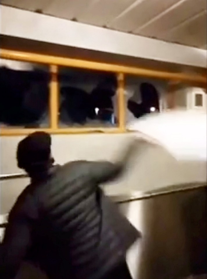 A Stoke fan throwing a sink through a window during a cup game against Port Vale in 2018