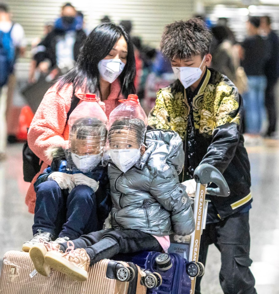 Children wearing improvised face protection made from water bottles in order to protect against the coronavirus Guangzhou airport