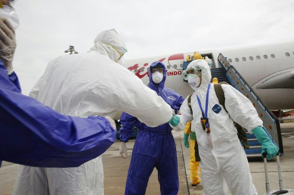  Officials in full protective gear upon the arrival of Indonesian students at Hang Nadim international airport