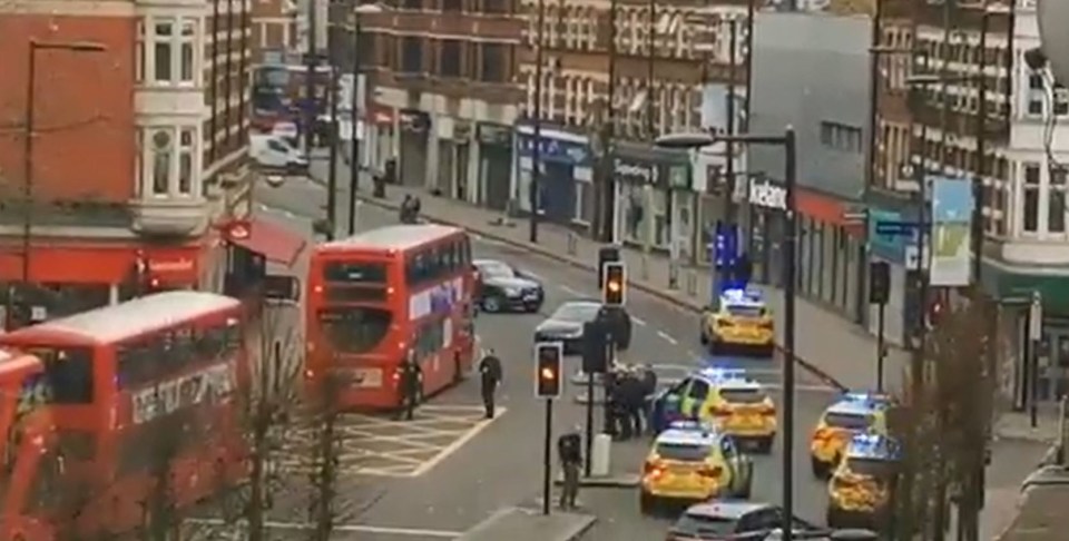  Dozens of cops flooded onto the busy high street this afternoon