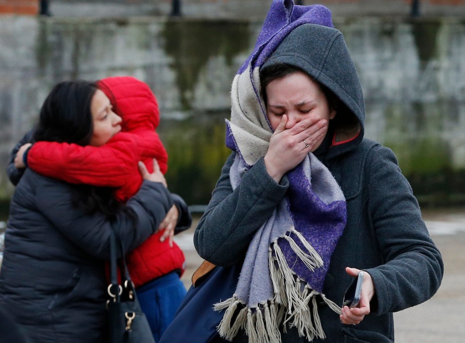 A woman holds her mouth in shock after the attack in Streatham