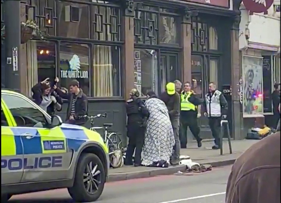 A blanket is wrapped around one of the victims in Streatham