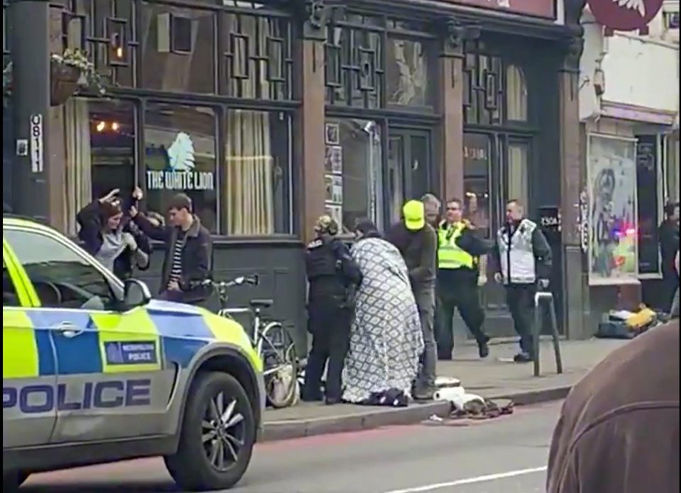  A blanket is wrapped around one of the victims in Streatham