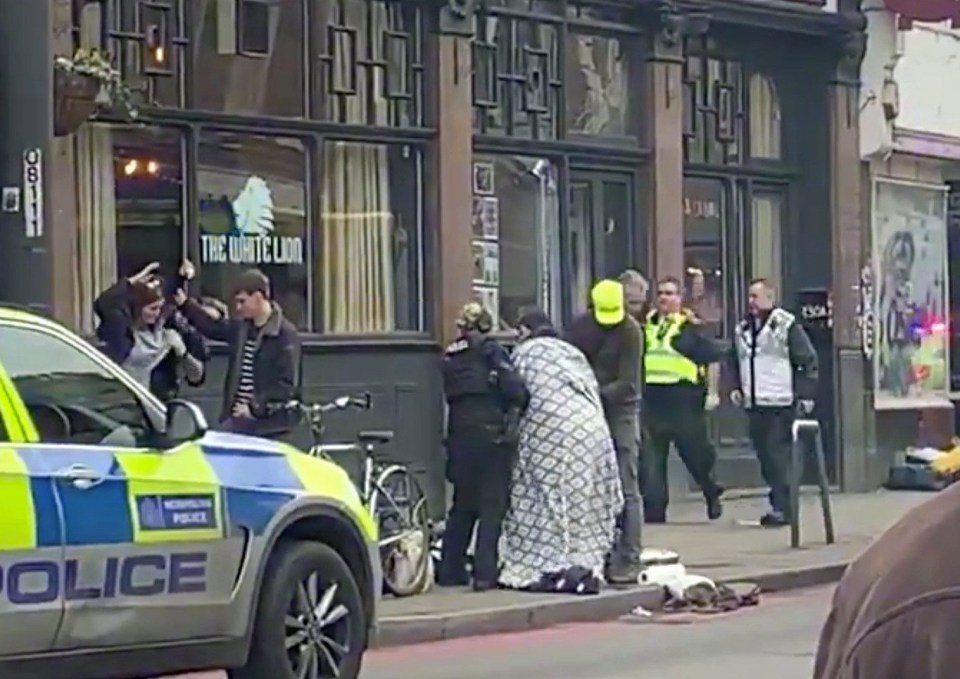 A blanket is wrapped around one of the victims in Streatham