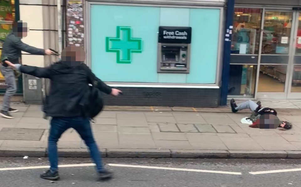  Undercover officers holding handguns swoop in on Sudesh Amman as he lies gunned down on the pavement in Streatham High Road