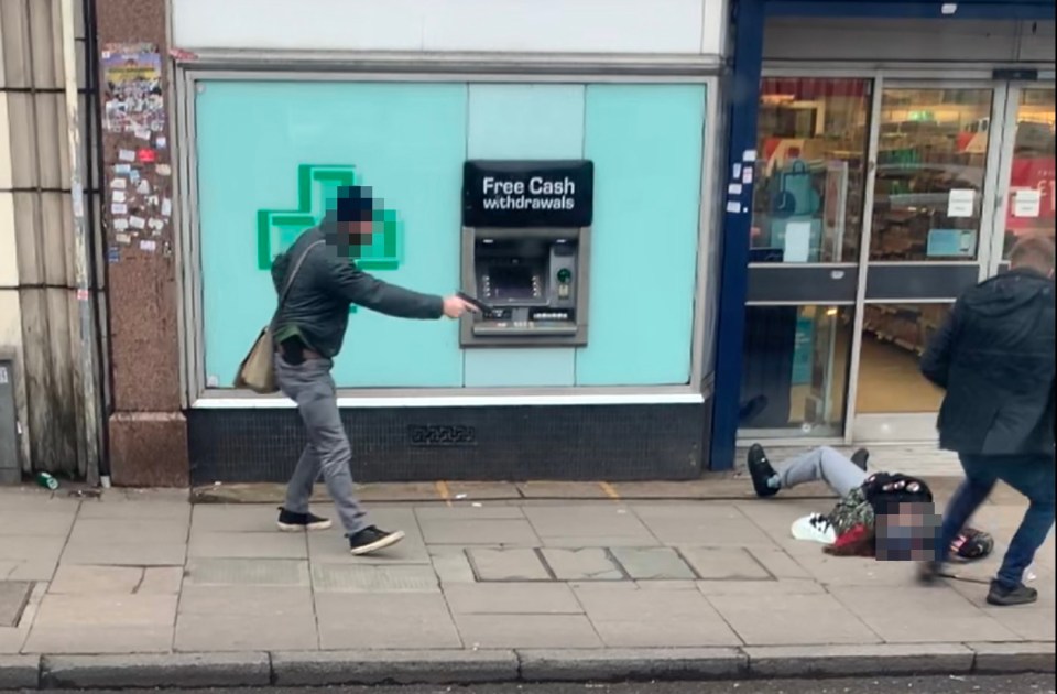 Undercover officers holding handguns swoop in on the suspect as he lies gunned down on the pavement in Streatham High Road