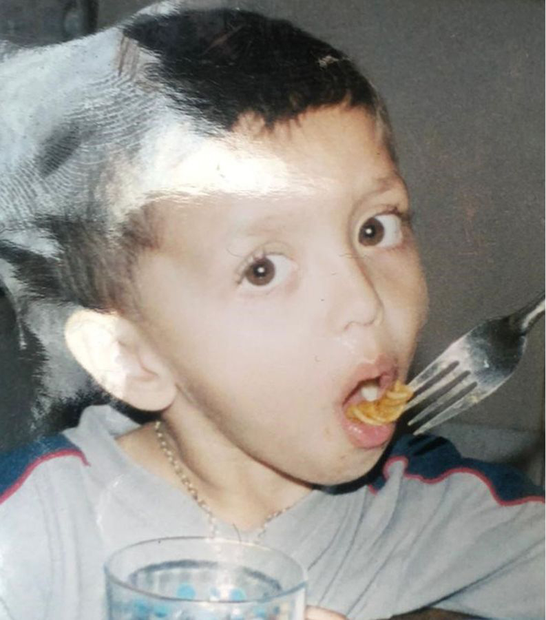 Amman – who was shot dead by armed police officers – eats pasta in a childhood picture