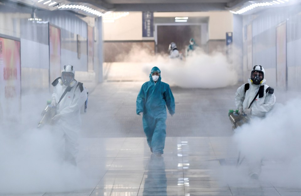  Volunteers in protective suits disinfect a railway station in Changsha, Hunan province, China, today