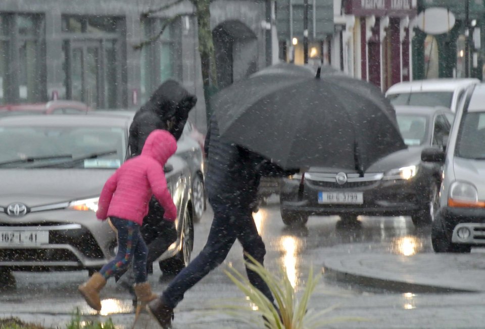  A family caught in the heavy rain and driving wind