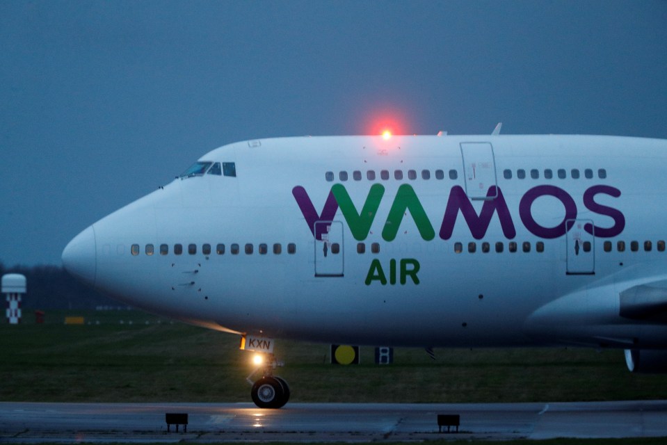 A plane carrying passengers from China lands at RAF Brize Norton near Oxford