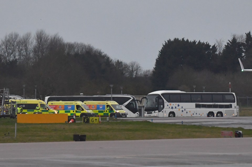 Coaches can be seen waiting to take the evacuees to quarantine