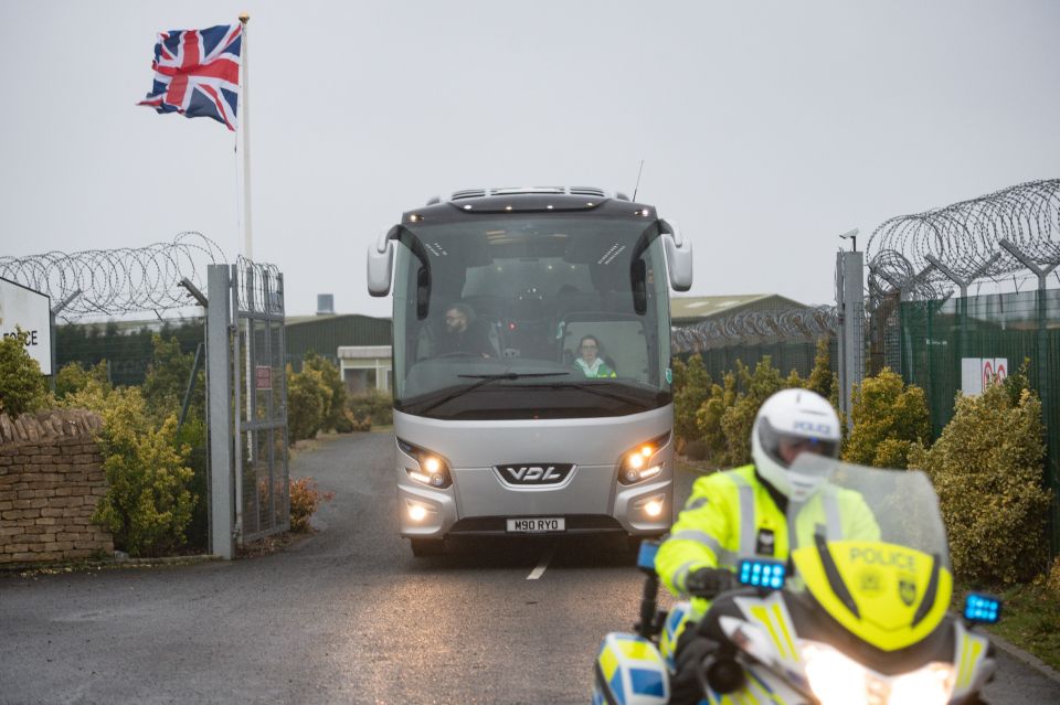  A coach is escorted by police to the quarantine