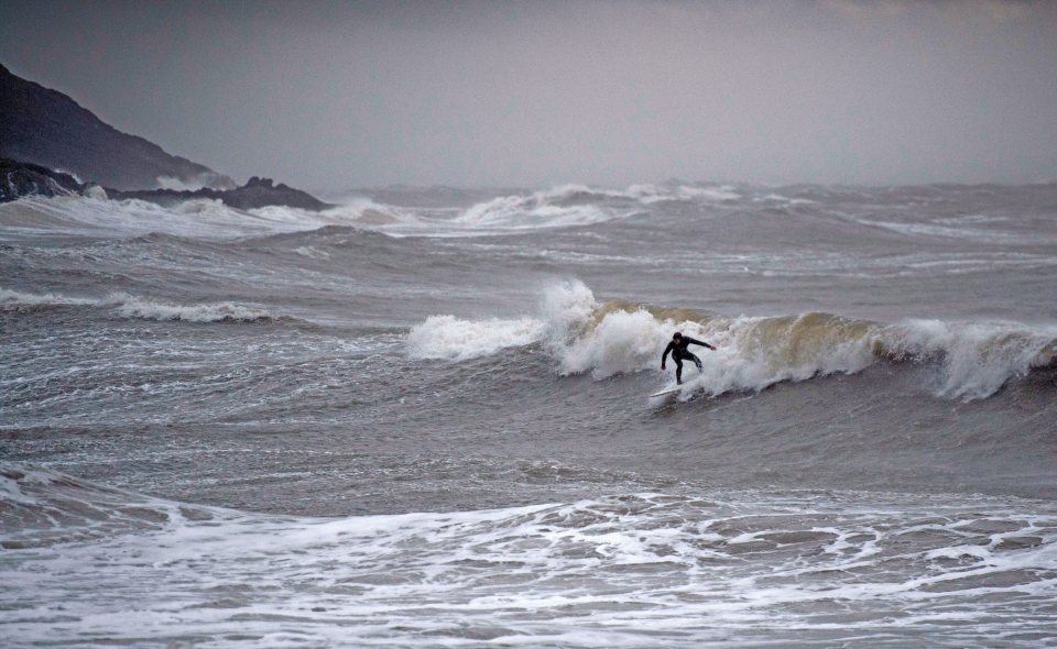  A lone surfer braves the gales and rain to make the most of the huge waves provided by Storm Ciara in Swansea