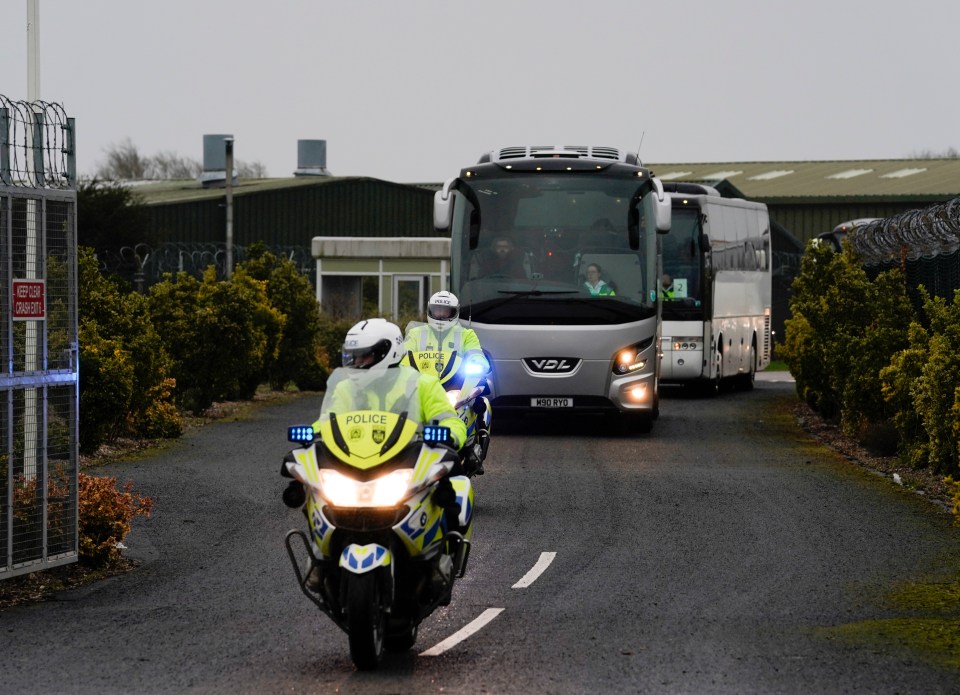 Police on motorbikes escort the bus on its way to quarantine