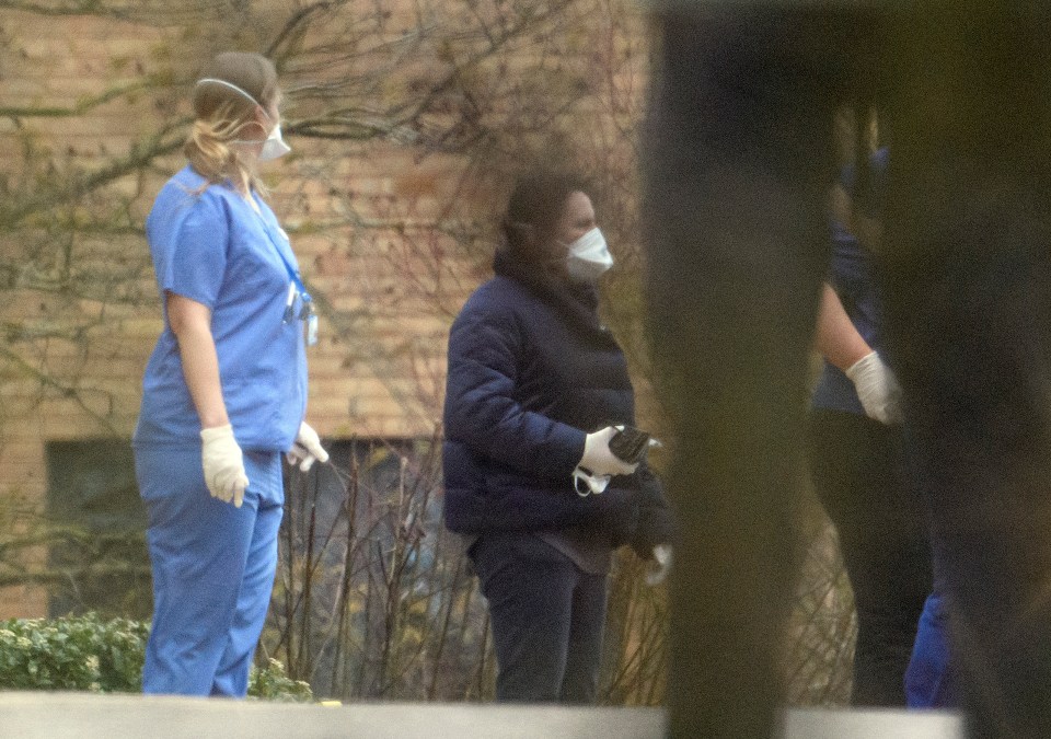 Medics greet passengers evacuated from Wuhan in China arrive at a facility in Milton Keynes