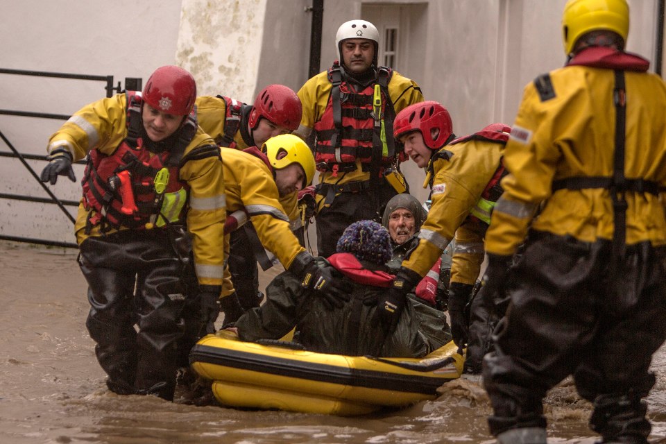  An elderly couple are rescued from their flooded home in Bangor, North Wales