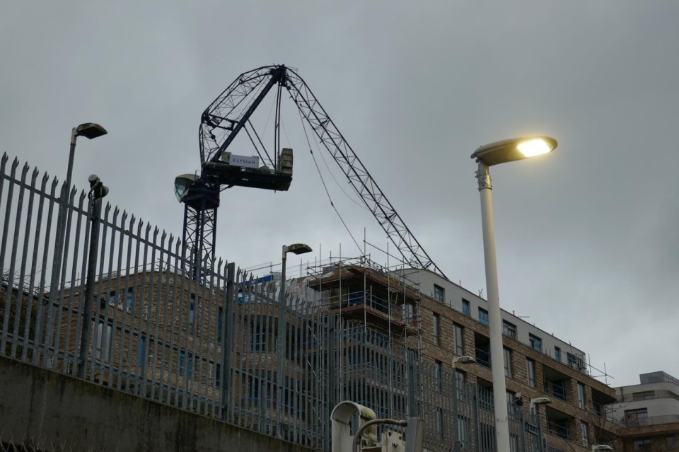 A crane is seen bent in half after the strong winds in North West London