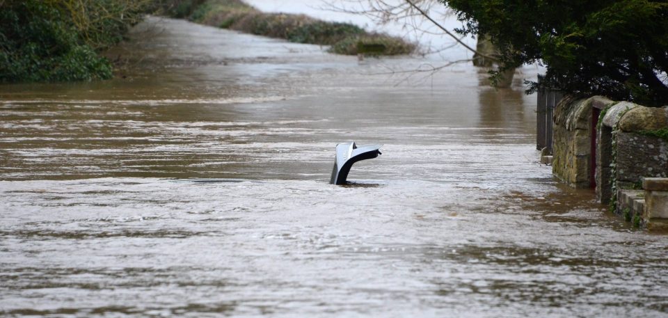  Two vehicles are submerged in flood water on Well Bank in Corbridge, Northumberland