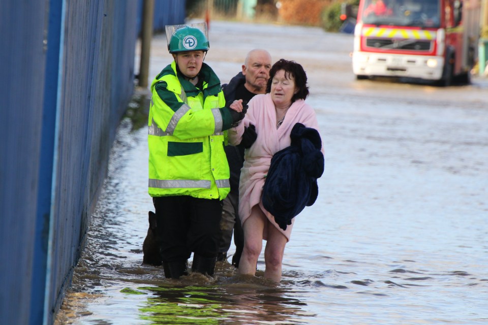  A stranded woman is rescued in the devastating floods in Bury, Greater Manchester