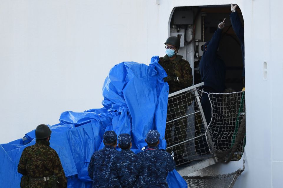  They erected covers over a gangway to take infected cruise passengers to hospital