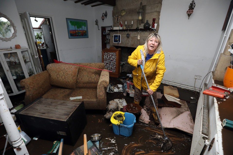  Karen Smith starts the clear up after Storm Ciara wrecked her home in Mytholmroyd