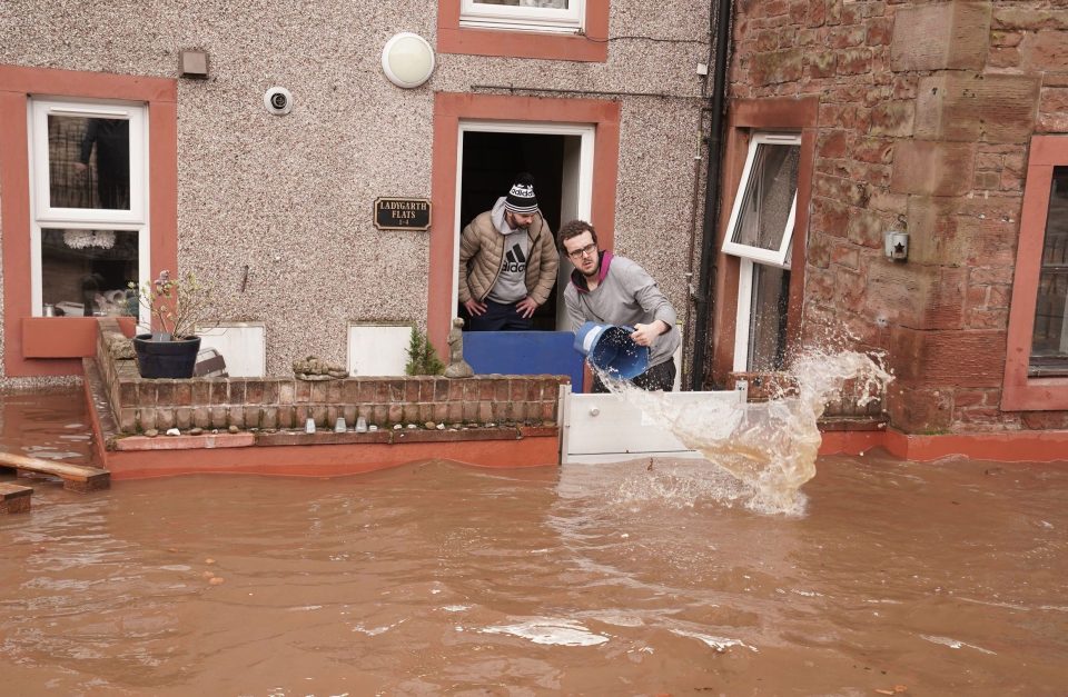  Residents begin to clean up their homes in the flooded streets in Appleby-in-Westmorland, Cumbria