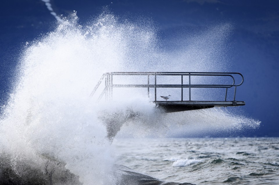  A huge wave crashes over a pier on Lake Geneva, Switzerland, as Storm Ciara wreaks havoc across Europe