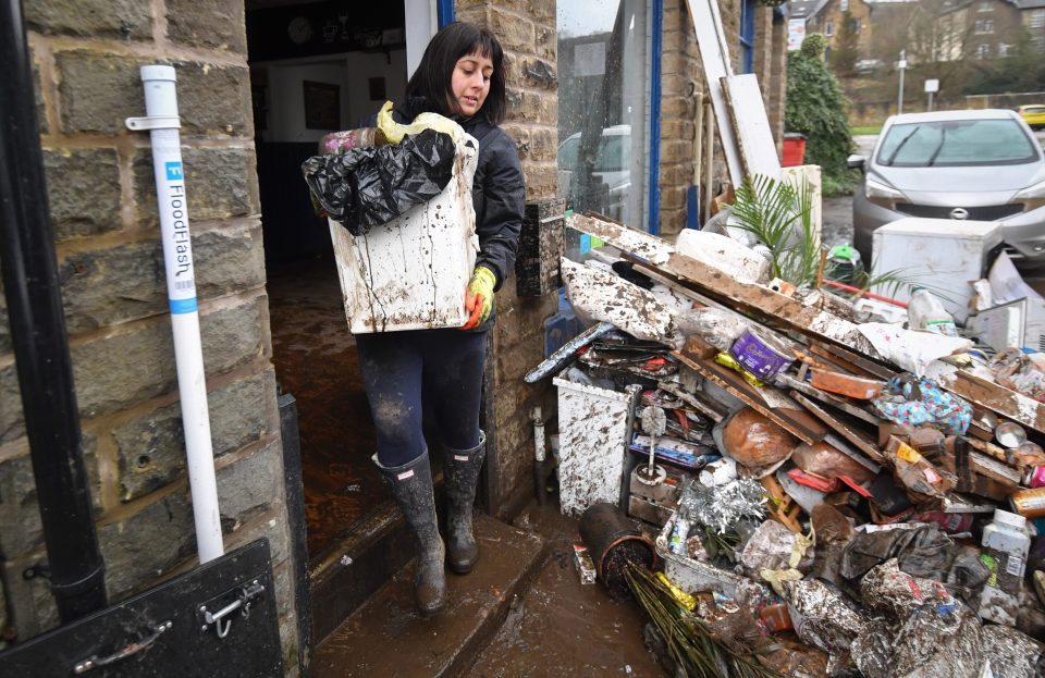  Staff beginning cleaning the Blue Tea Pot cafe as residents begin clearing up following severe flooding