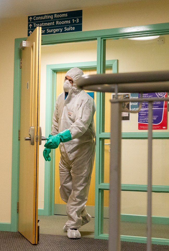 Workers in hazmat suits were pictured cleaning the surgery yesterday