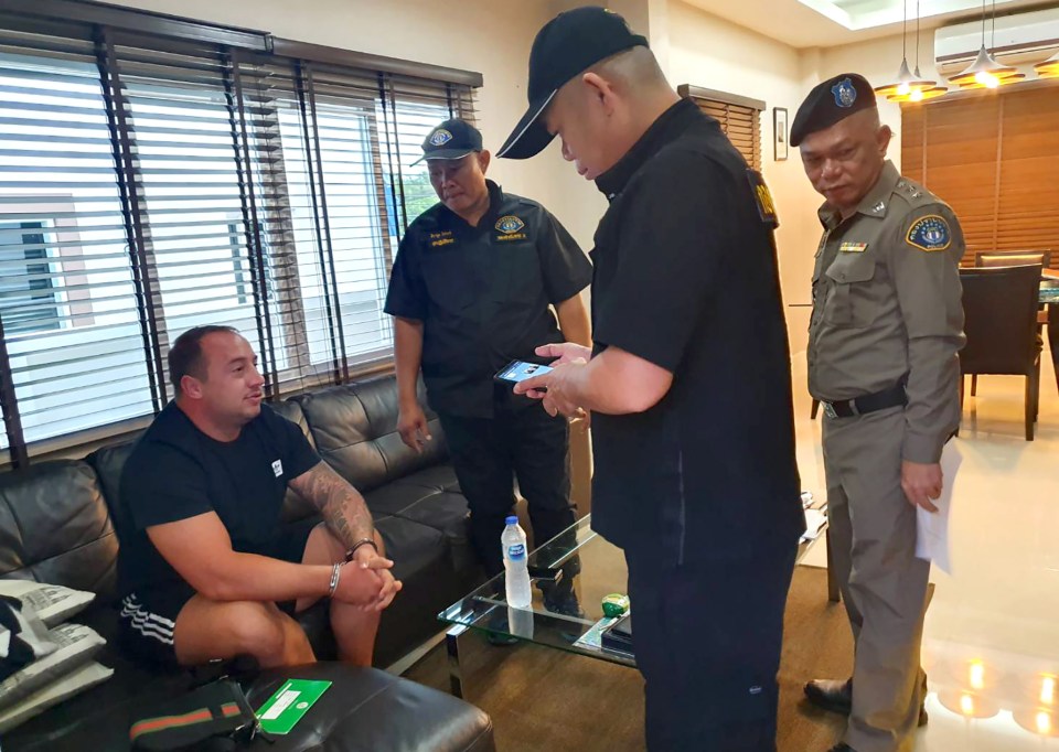  Royal Thai Police released this photograph of officers speaking to Mark John Rumble over the suspected corona-virus outbreak