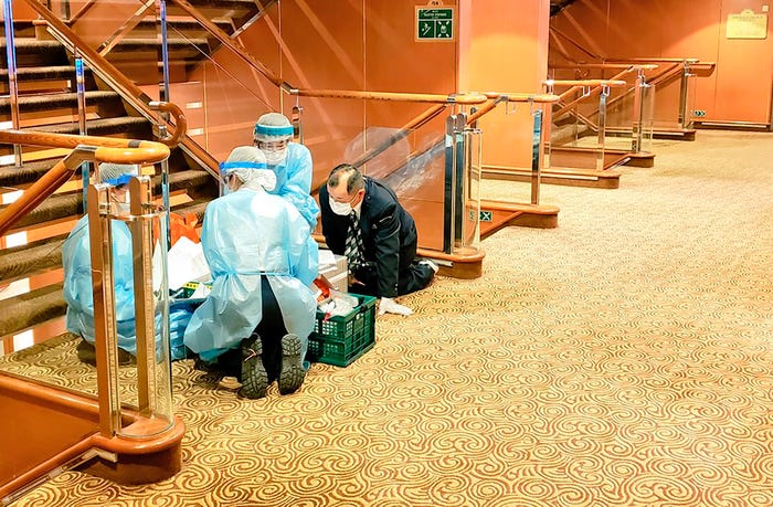 Medics treat a patient on board the Diamond Princess