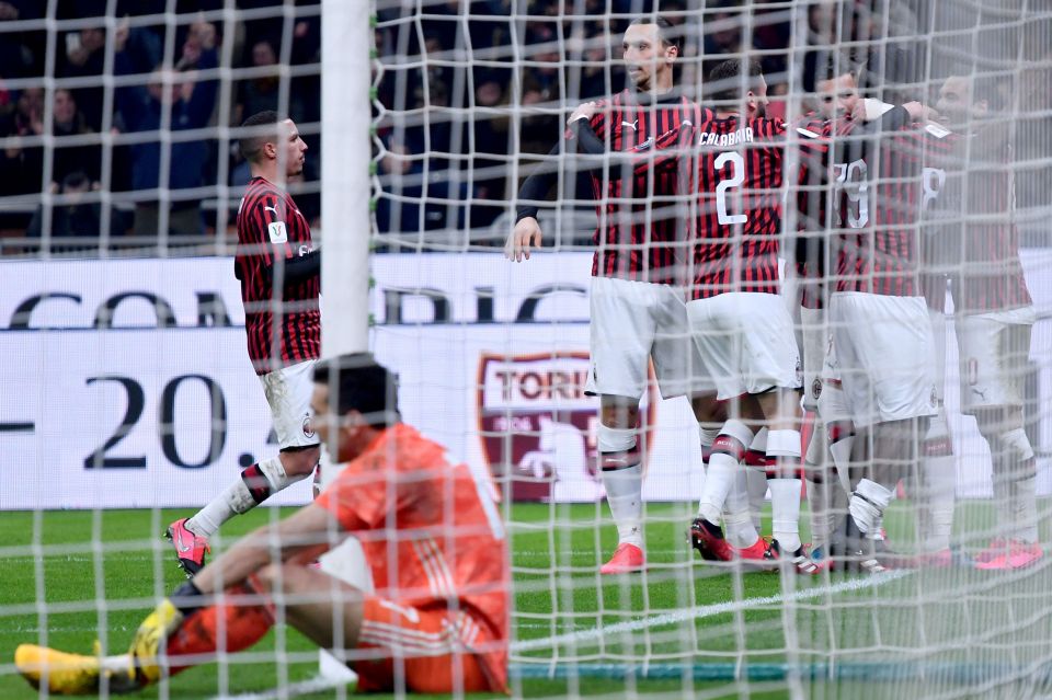  Veteran keeper Gianluigi Buffon sits as Milan players celebrate the opener