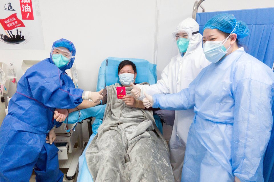  A recovered coronavirus patient from Huanan seafood market holds a certificate for blood donation while donating plasma at Wuhan Blood Center in Wuhan