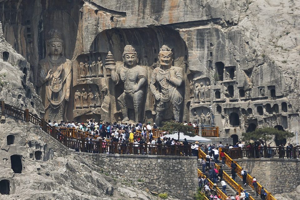  Tourists at Longmen Grottoes in Henan Province, a trail of 2,300 caves and niches containing the largest collection of Chinese art of the late Northern Wei and Tang Dynasties