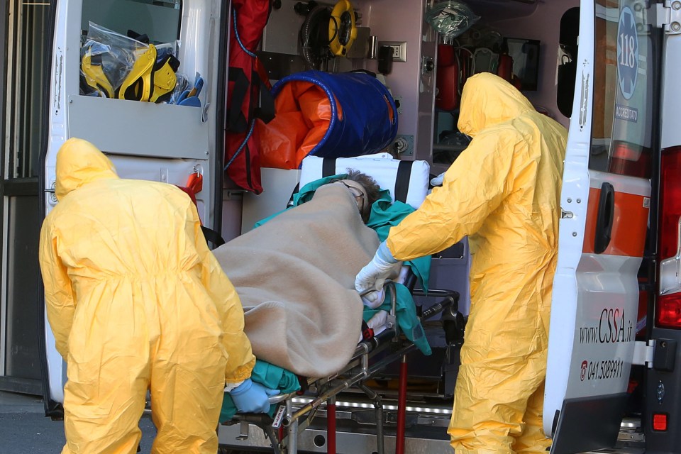  Ambulances and health workers are seen transporting a patient outside the Padua's Hospital, northern Italy