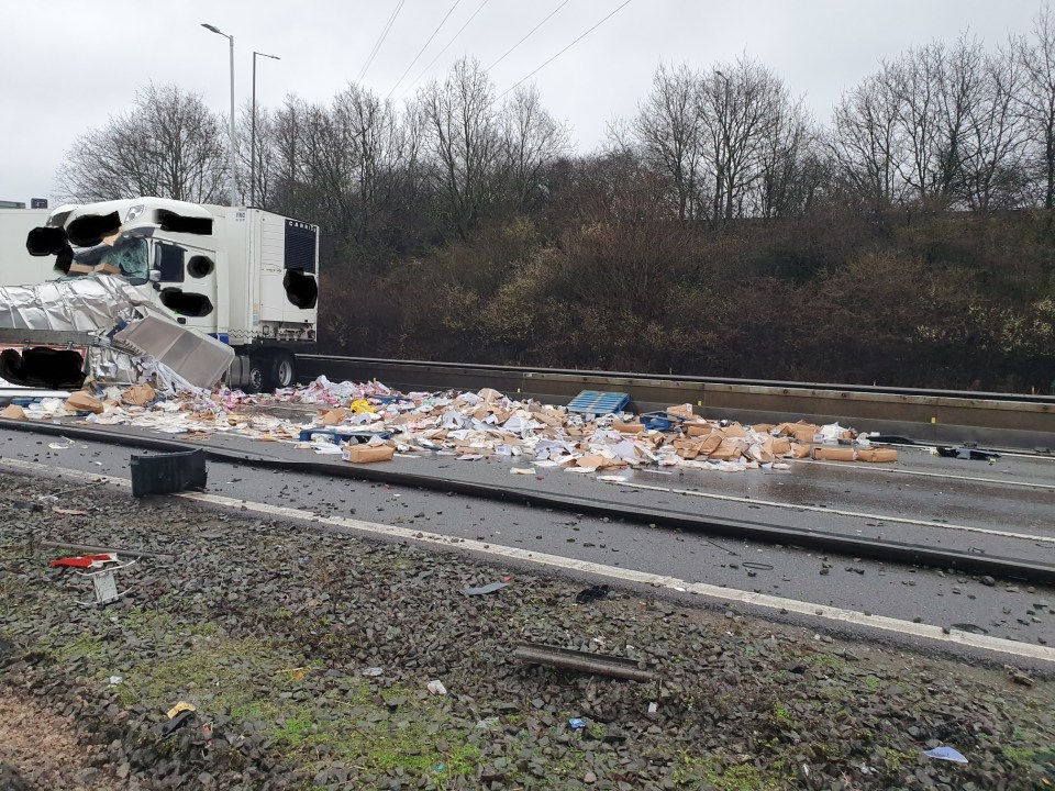  Dramatic pictures show one lorry on its side with debris scattered over the motorway