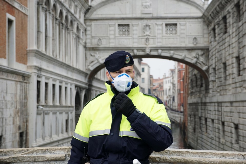  A cop in Venice wears a protective mask as the city's carnival is shutdown over coronavirus fears