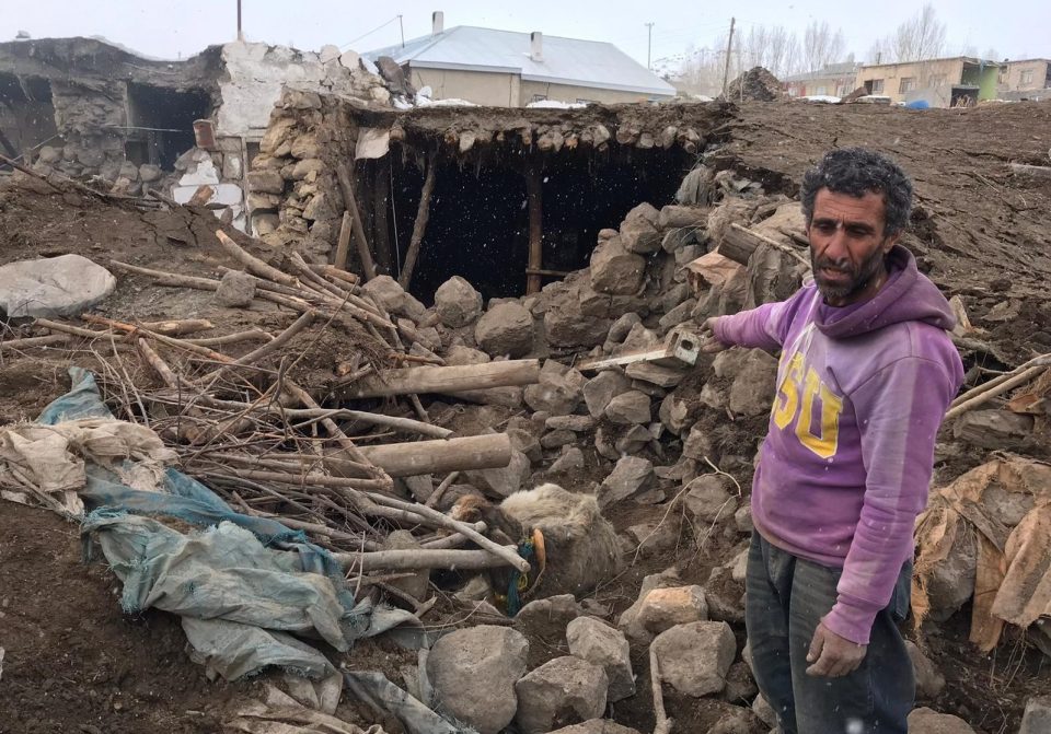  A man is seen at a collapsed building after the earthquake struck near the border with Iran