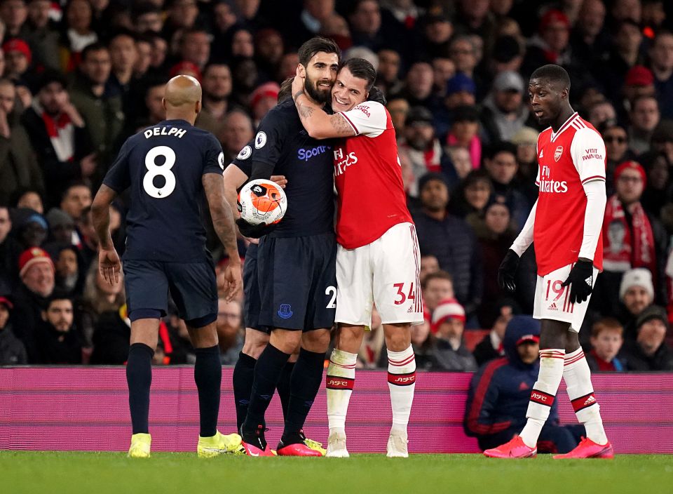  Andre Gomes and Granit Xhaka share an embrace at the Emirates after Gomes returned to action