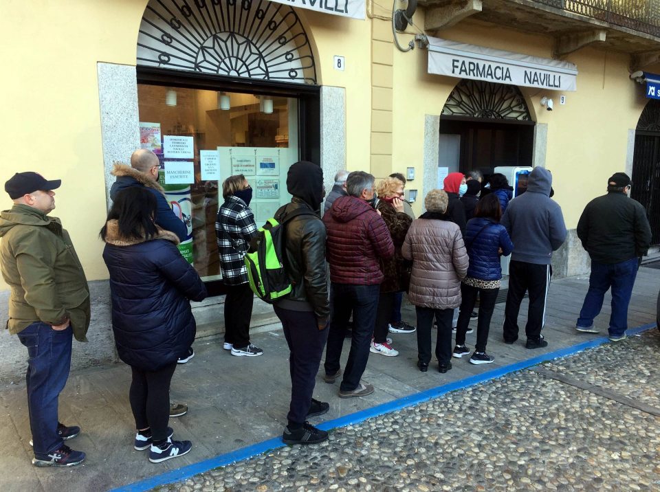  People queue at a pharmacy in Codogno, Italy, after the coronavirus outbreak